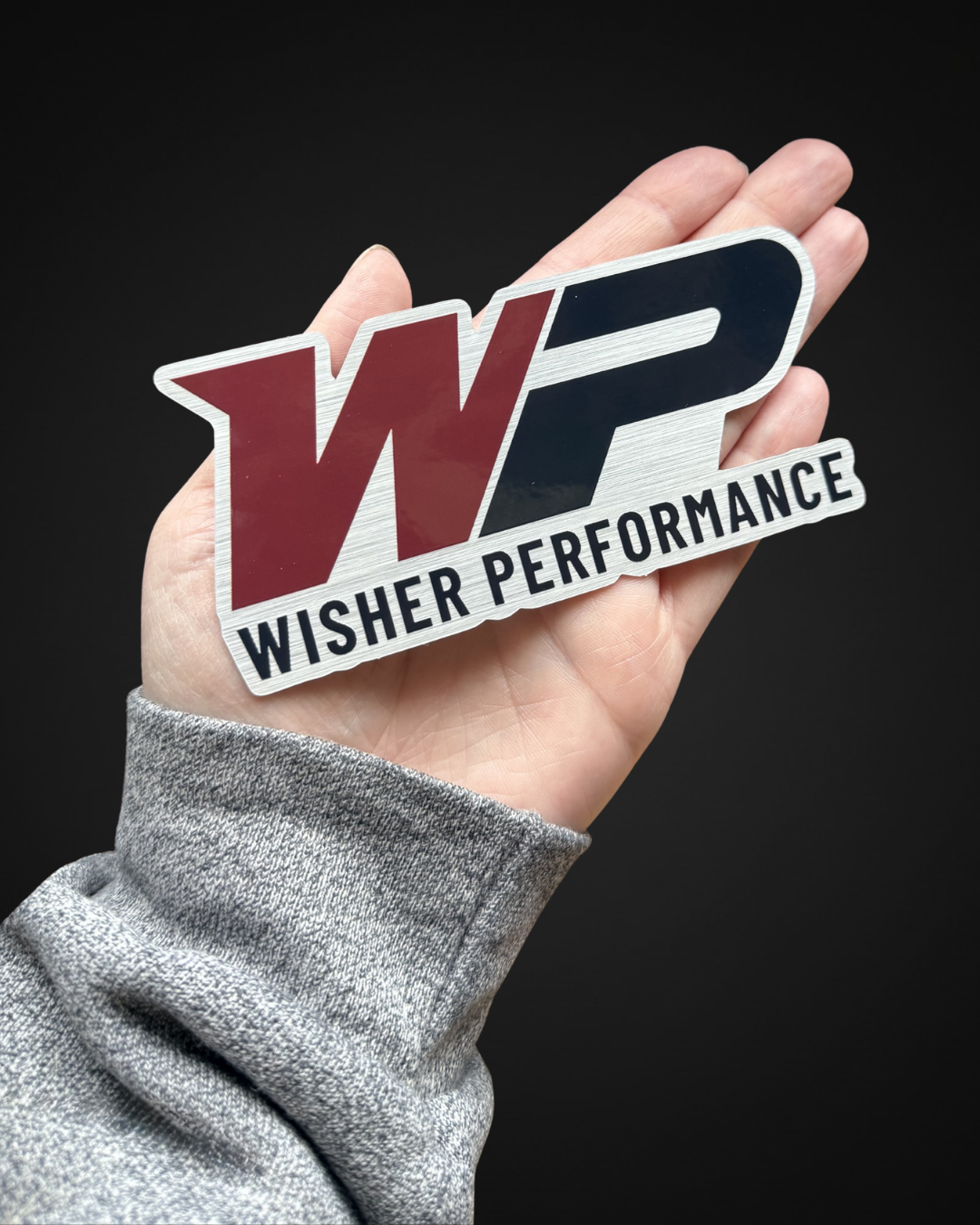 5” x 2.3” Brushed aluminum die cut sticker featuring the Wisher Performance logo.