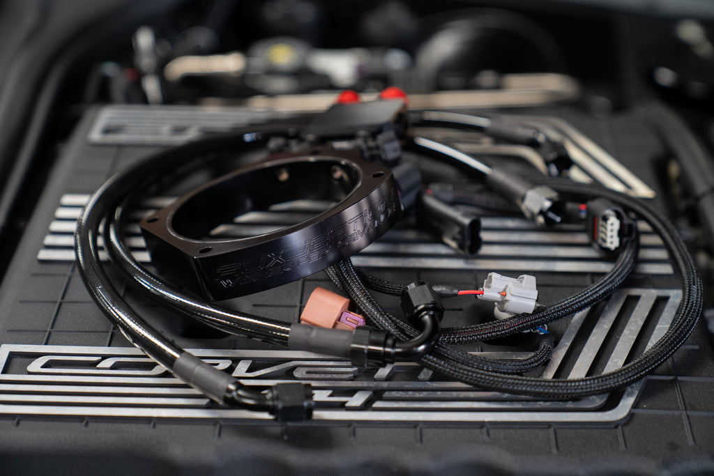Wisher Performance AuxJection kit for GM LT4 engines, featuring the black billet adapter plate, fuel lines, and plug-and-play wiring harness for factory ECU integration.