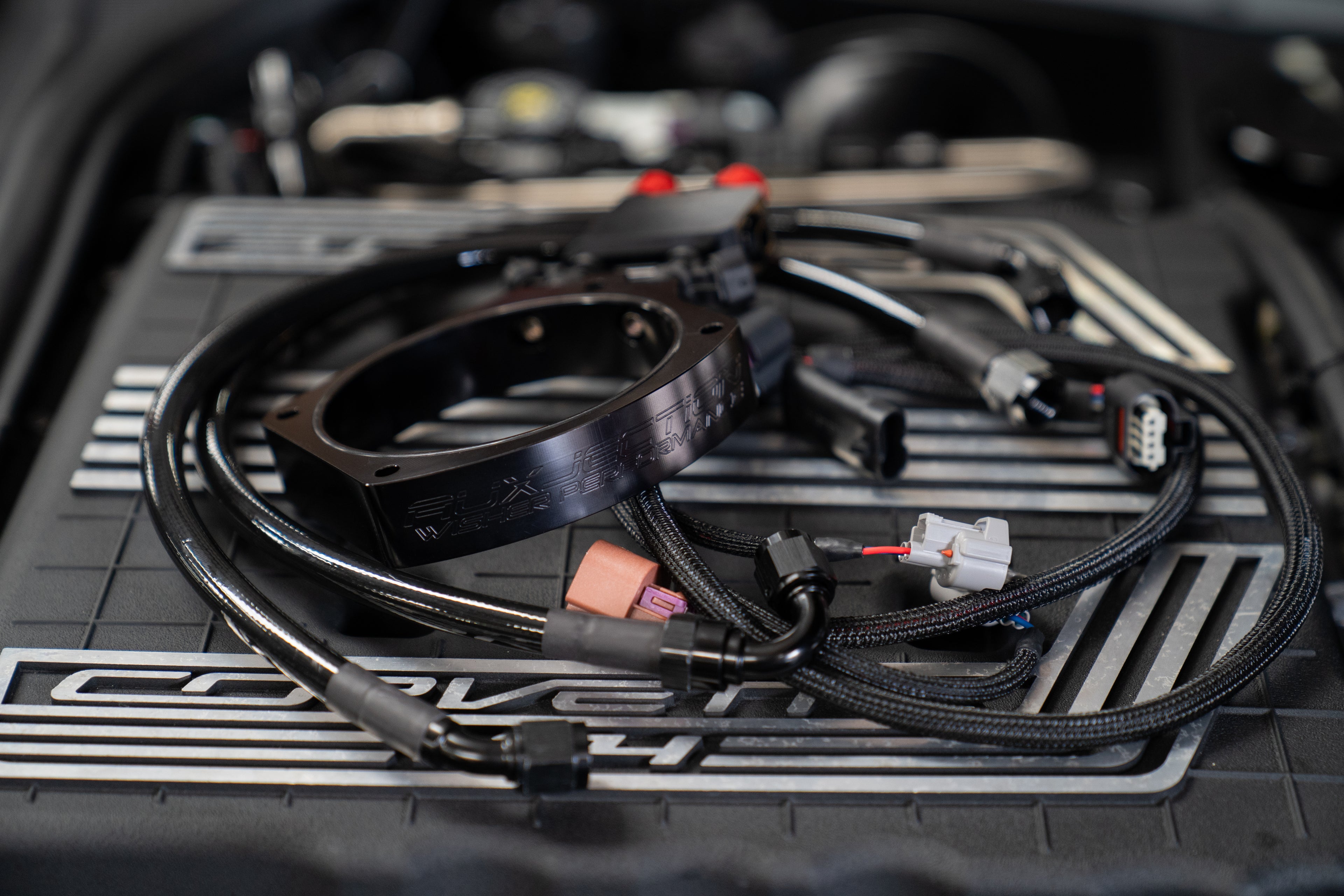 Wisher Performance AuxJection kit for GM LT4 engines, featuring the black billet adapter plate, fuel lines, and plug-and-play wiring harness for factory ECU integration.